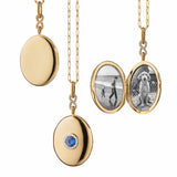 Monica Rich Kosann oval locket with center blue sapphire and surrounding diamonds on delicate 30" belcher chain